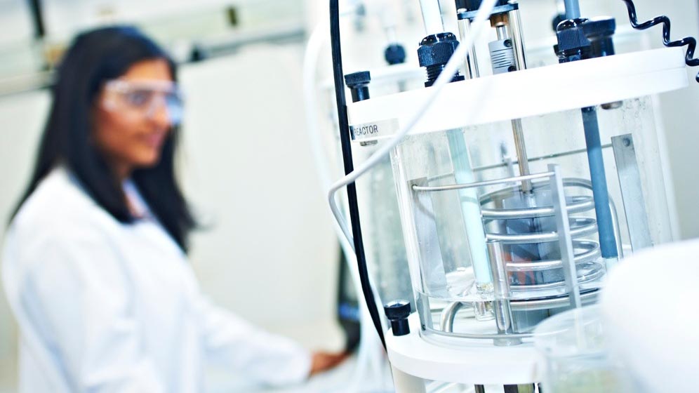 A student working with chemical engineering equipment