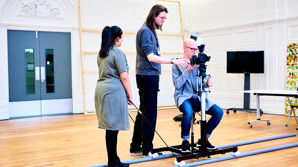 A student using some camera equipment