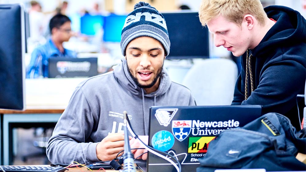 Two students talking over work