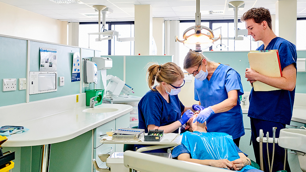 Trainee dentists performing a dental procedure