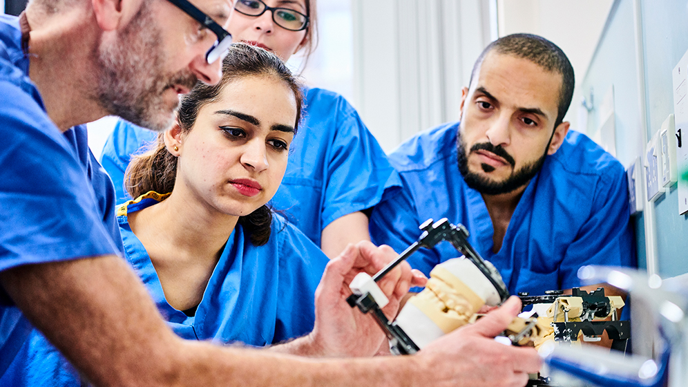 Trainee Dentists looking at equipment