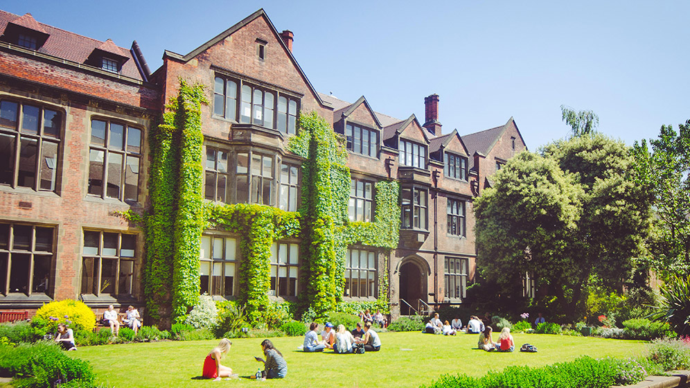 Students sitting in the Newcastle University Quadrangle