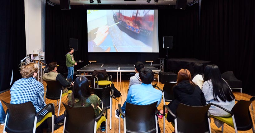 Students watching a non-fiction film during a class