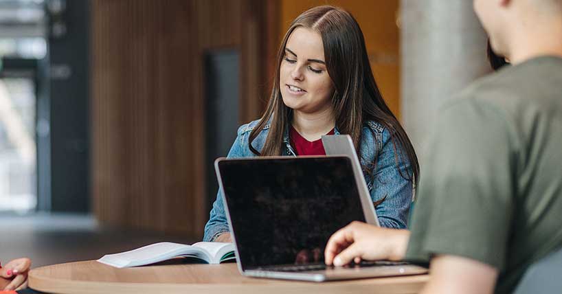 Student working with laptop in view.