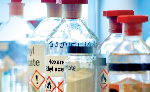 A bottle of chemicals on a lab bench