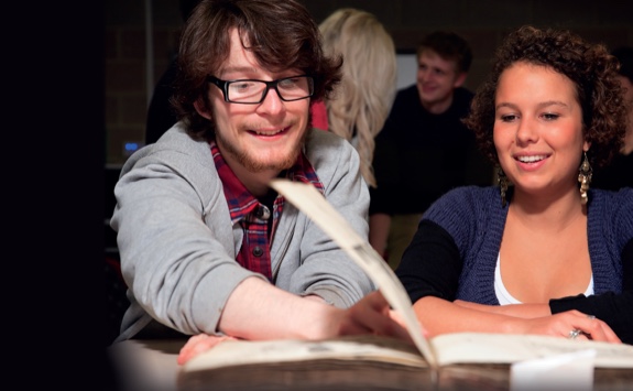 Students looking at an old book