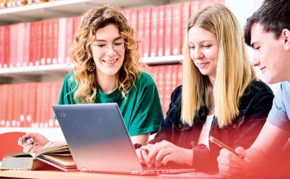 Students working at a laptop