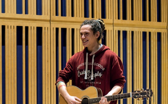 A student playing a guitar