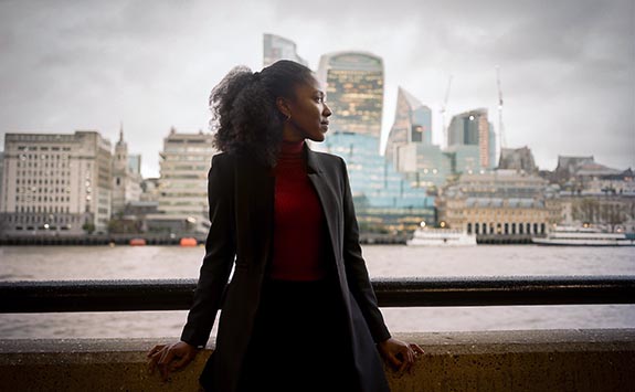 Natasha Brown standing in front of the River Thames in London
